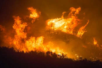 hills on fire in multiple spots at night